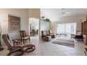 Spacious open-concept living area with tile floors and large windows that leads into an open dining room at 1872 Birmingham Blvd, Port Charlotte, FL 33980