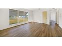 Bright living room featuring wood-look flooring and a large window at 22220 Lasalle Rd, Port Charlotte, FL 33952