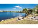 Scenic waterfront backyard with a charming bench to enjoy the lake view at 2244 Meetze St, Port Charlotte, FL 33953
