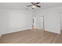 Bright bedroom with light-colored wood flooring and a modern ceiling fan at 2300 Nordendale Blvd, North Port, FL 34288