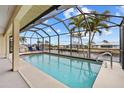 Screened-in pool area with views of the canal, offering a relaxing outdoor space at 2310 El Cerito Ct, Punta Gorda, FL 33950