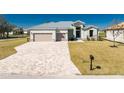 Charming home featuring a spacious driveway and attached two-car garage at 24294 Santa Inez Rd, Punta Gorda, FL 33955