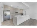 This spacious, modern kitchen has stainless steel appliances, quartz countertops and backsplash, and recessed lighting at 24294 Santa Inez Rd, Punta Gorda, FL 33955