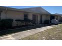 Inviting single-story villa with clean exterior and trimmed shrubs, offering a cozy curb appeal at 25068 Harborview Rd # 3D, Punta Gorda, FL 33980