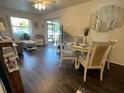 Bright living room featuring stylish decor, wood floors, and access to a screened patio at 25068 Harborview Rd # 3D, Punta Gorda, FL 33980