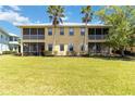 Spacious backyard with palm trees and a well-maintained lawn, offering great outdoor living at 25559 Heritage Lake Blvd # 25, Punta Gorda, FL 33983