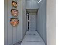 Entrance to the home decorated with colorful hanging planters at 3106 Heron Shores Dr, Venice, FL 34293
