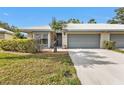 Charming single-story home featuring a well-maintained lawn and an attached two-car garage at 3106 Heron Shores Dr, Venice, FL 34293