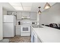Well-lit kitchen featuring modern appliances and a seamless flow into the living space at 3310 Loveland Blvd # 1102, Punta Gorda, FL 33980