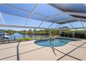 Secluded, screened-in pool with scenic views of the canal and surrounding landscape at 4146 Library St, Port Charlotte, FL 33948