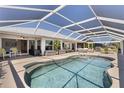 Enjoy the expansive screened-in pool area with ample seating and access to the home at 4146 Library St, Port Charlotte, FL 33948