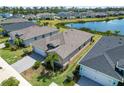An aerial view showcases this single Gathering home in a lakeside community with mature landscaping at 43839 Seedling Ter, Punta Gorda, FL 33982