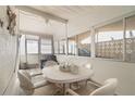 Bright, enclosed patio featuring tile floors, plenty of natural light, and a cozy seating area at 5179 Grobe St, North Port, FL 34287