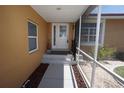 Covered entryway leading to a front door with glass inserts and a view of the surrounding landscaping at 612 Macedonia Dr, Punta Gorda, FL 33950