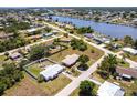 Aerial view of a neighborhood showcasing the home's proximity to the water and surrounding properties at 661 Athos Ter, Port Charlotte, FL 33952