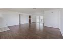 Spacious living room with wood-look flooring and a sliding glass door leading to the outdoor area at 661 Athos Ter, Port Charlotte, FL 33952
