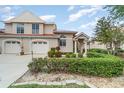 Charming two-story home with manicured landscaping and a white stucco facade at 814 Via Tripoli, Punta Gorda, FL 33950