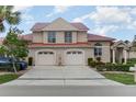 Charming two-story home with a rust colored roof, manicured landscaping, and a two-car garage at 814 Via Tripoli, Punta Gorda, FL 33950