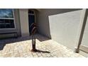 Close-up of the entryway with a decorative metal bird statue, brick pavers, and view of the front door at 2836 Suncoast Lakes Blvd, Punta Gorda, FL 33980