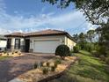 Well-maintained single-story home with a two-car garage and a neatly landscaped yard at 1263 Cicely Ct, North Port, FL 34289