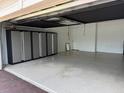 Spacious garage with epoxy flooring and ample storage cabinets at 1263 Cicely Ct, North Port, FL 34289