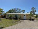 Inviting single-story home with a gravel drive and well-maintained landscaping at 1270 Manor Rd, Englewood, FL 34223