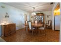 Traditional dining room featuring a wood table, chandelier, and built-in china cabinet at 1497 Fireside St, Port Charlotte, FL 33952