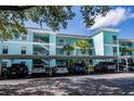 Beautiful condominium building with lush landscaping and covered parking at 19385 Water Oak Dr # 302, Port Charlotte, FL 33948