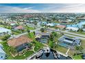Waterfront home featuring private boat docks and a screened-in pool, set within a vibrant community and canal system at 200 Capri Isles Ct, Punta Gorda, FL 33950