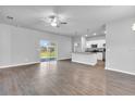 Bright living area with hardwood floors, sliding glass doors, and an open view to the kitchen at 20241 Lorette Ave, Port Charlotte, FL 33954