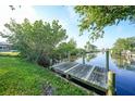 Wooden dock on a calm canal, perfect for boating and enjoying the waterfront lifestyle at 21249 Higgs Dr, Port Charlotte, FL 33952