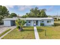 Inviting single-story home with a well-maintained lawn and decorative front accents at 21249 Higgs Dr, Port Charlotte, FL 33952