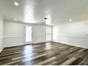 Spacious living room featuring stylish wood floors, neutral colors, and ample natural light at 2600 Mohegan Rd, Venice, FL 34293