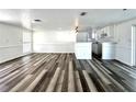 Open-concept living area with wood floors seamlessly connects the living room and kitchen at 2600 Mohegan Rd, Venice, FL 34293