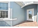 Inviting front entrance with a brick pathway, decorative window, and 'Welcome' sign for a warm greeting at 28059 Arrowhead Cir, Punta Gorda, FL 33982