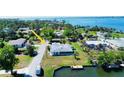 Aerial view of a well-maintained house and waterfront with dock in a desirable neighborhood at 352 Oak St, Englewood, FL 34223