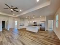 Open-concept kitchen and living area with white cabinets, granite countertops, and stainless steel appliances at 369 Biltmore St, Port Charlotte, FL 33953