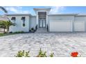 Charming single-story home boasts a manicured lawn and a spacious brick driveway at 3712 Carmichael Dr, Punta Gorda, FL 33950