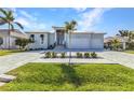 Well-maintained single-story home featuring an expansive brick driveway and neatly trimmed lawn at 3712 Carmichael Dr, Punta Gorda, FL 33950