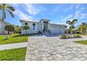 Inviting single story home with a well-kept lawn and beautiful brick driveway at 3712 Carmichael Dr, Punta Gorda, FL 33950