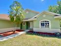 Inviting single-story home boasting lush green lawn and mature trees in a serene neighborhood at 3721 Adelaide Ave, North Port, FL 34288