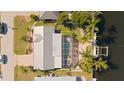 Aerial shot displays a screened-in pool, private boat dock, and canal-front living at 441 Norma Ct, Punta Gorda, FL 33950