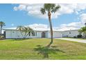 Beautiful single-Gathering home with palm trees, a metal roof, and a well-maintained lawn at 5194 Cooper Ter, Port Charlotte, FL 33981
