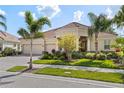 Lovely single-story home with three-car garage, paved driveway, red tile roof, and mature landscaping at 5428 Royal Poinciana Way, North Port, FL 34291