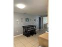 Cozy kitchen with tile flooring, a dining table and views into other rooms at 705 Crestview Nw Cir, Port Charlotte, FL 33948