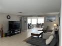 Spacious living room with tile flooring and a large window providing natural light at 705 Crestview Nw Cir, Port Charlotte, FL 33948