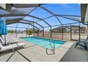Inviting screened-in pool with lounge chairs for relaxing and enjoying the outdoors at 7434 Ashtabula St, Englewood, FL 34224