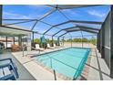 Lovely screened-in pool area with ample seating for entertaining and enjoying the outdoors at 7434 Ashtabula St, Englewood, FL 34224