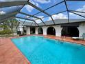 Screened-in pool with ample brick patio area and access to the main house at 1305 Alton Rd, Port Charlotte, FL 33952