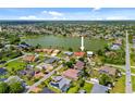 Aerial view shows the single Gathering home nestled within a community of homes near a lake at 149 Albert Ln, Port Charlotte, FL 33954